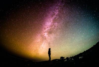 night sky with stars and standing person